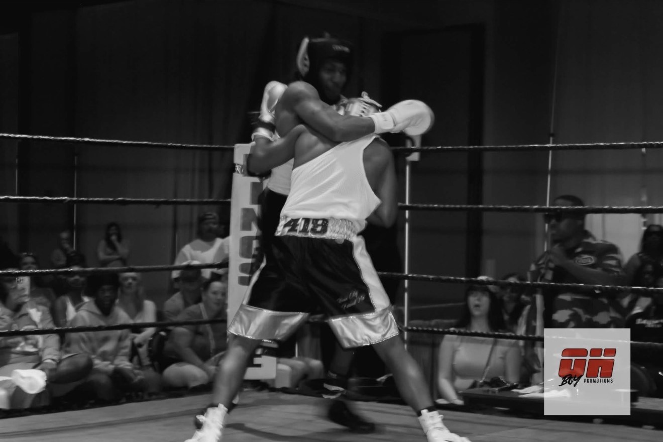Boxers trading blows in the ring at an Oh Boy Promotions fight night